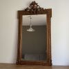 Miroir doré fin 19ème avec  fronton décoré. 150x82.