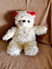 Peluche vintage Ours blanc Boulgom à nœuds rouges.